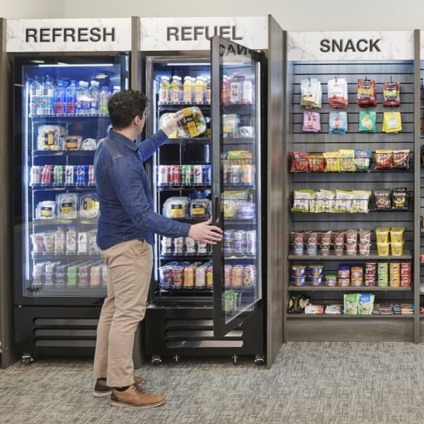 A resident grabbing a drink from a Refresh, Refuel and Snack micro market